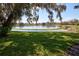 Lush backyard showcasing lake view and mature trees at 781 Lakeworth Cir, Lake Mary, FL 32746