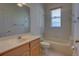 Neutral bathroom with single sink vanity, a window with blinds, and a shower over tub at 781 Lakeworth Cir, Lake Mary, FL 32746