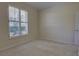 This carpeted bedroom has a single window with shutter and a bright, neutral color palette at 781 Lakeworth Cir, Lake Mary, FL 32746