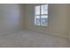 This carpeted bedroom has a single window with shutter and a bright, neutral color palette at 781 Lakeworth Cir, Lake Mary, FL 32746