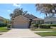 Charming home featuring a manicured lawn, mature landscaping, and a two-car garage at 781 Lakeworth Cir, Lake Mary, FL 32746