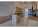 Kitchen featuring wood cabinetry, granite countertops, stainless steel appliances, and a breakfast bar open to the living room at 781 Lakeworth Cir, Lake Mary, FL 32746
