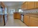 Kitchen featuring wood cabinetry, granite countertops, stainless steel appliances, and an eat-in dining area at 781 Lakeworth Cir, Lake Mary, FL 32746