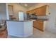 Kitchen featuring wood cabinetry, granite countertops, stainless steel appliances, and a breakfast bar at 781 Lakeworth Cir, Lake Mary, FL 32746
