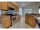 Kitchen featuring wood cabinetry, granite countertops, stainless steel appliances, and an eat-in dining area at 781 Lakeworth Cir, Lake Mary, FL 32746