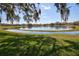 Scenic lake view framed by lush green lawn and mature trees, offering a peaceful ambiance at 781 Lakeworth Cir, Lake Mary, FL 32746
