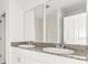 Bathroom featuring double sinks, granite countertop, ample cabinet space, and modern fixtures at 792 Griffon Ave, Lake Alfred, FL 33850