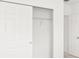 Bedroom featuring built-in closet with sliding doors, door access at 792 Griffon Ave, Lake Alfred, FL 33850