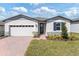 Charming single-story home with a two-car garage and a well-manicured front yard at 792 Griffon Ave, Lake Alfred, FL 33850