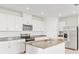 Modern kitchen featuring white cabinets, stainless steel appliances, and a center island at 792 Griffon Ave, Lake Alfred, FL 33850