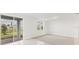 Bright living room featuring a large window, sliding glass door and neutral wall and flooring at 792 Griffon Ave, Lake Alfred, FL 33850