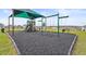 Community playground featuring swings, slides, and a shaded area for fun and recreation at 792 Griffon Ave, Lake Alfred, FL 33850