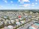 Expansive aerial view of colorful homes in a vibrant resort community with lush landscaping at 8086 Knee Deep Rd, Kissimmee, FL 34747