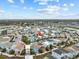 Aerial view of a neighborhood with colorful homes, green spaces and a scenic landscape at 8086 Knee Deep Rd, Kissimmee, FL 34747