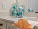 Decorated bathroom featuring quartz countertop, white cabinetry, and modern decor at 8086 Knee Deep Rd, Kissimmee, FL 34747