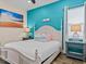 Stylish bedroom features a white bed frame with turquoise accent wall at 8086 Knee Deep Rd, Kissimmee, FL 34747