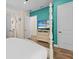 Bright bedroom with hardwood floors, TV, and white wood 4 poster bed frame at 8086 Knee Deep Rd, Kissimmee, FL 34747