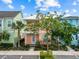 Charming two-story home with colorful facade, landscaping, and a welcoming front porch at 8086 Knee Deep Rd, Kissimmee, FL 34747