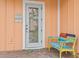 Welcoming front door with colorful bench and decorative accents at 8086 Knee Deep Rd, Kissimmee, FL 34747