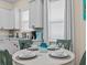 Cozy dining area adjacent to a well-appointed kitchen with white cabinets at 8086 Knee Deep Rd, Kissimmee, FL 34747
