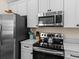 Bright kitchen featuring stainless steel appliances, and ample counter space at 8086 Knee Deep Rd, Kissimmee, FL 34747