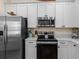 Well-equipped kitchen featuring stainless steel appliances and white cabinetry at 8086 Knee Deep Rd, Kissimmee, FL 34747