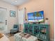 Cozy living room featuring a teal cabinet, beach decor, and comfortable furnishings at 8086 Knee Deep Rd, Kissimmee, FL 34747