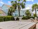 Outdoor table with margaritas overlooking colorful homes and palm trees at 8086 Knee Deep Rd, Kissimmee, FL 34747