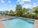Relaxing pool and spa area, surrounded by lush landscaping and other colorful homes at 8086 Knee Deep Rd, Kissimmee, FL 34747