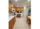 Functional kitchen with wooden cabinetry, white appliances, and a cozy breakfast nook at 9 Escondido Cir # 88, Altamonte Springs, FL 32701
