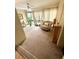 Relax in this sun-filled sitting area with neutral carpet, furniture, and tall windows at 9 Escondido Cir # 88, Altamonte Springs, FL 32701