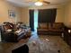 The living room features carpet and a large window to let in natural light, great for entertaining at 103 Blue Heron Ln, Casselberry, FL 32707