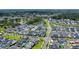 Scenic aerial view of a modern neighborhood with green spaces, ponds, and thoughtfully designed home exteriors at 1073 Sadler Oaks Way, Winter Garden, FL 34787