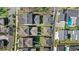 An aerial view shows a neighborhood of gray roofed homes with green lawns and carefully planned landscaping at 1073 Sadler Oaks Way, Winter Garden, FL 34787