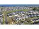 Aerial view of a lakeside residential community with manicured lawns, a central pond, and waterfront homes at 1073 Sadler Oaks Way, Winter Garden, FL 34787