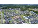 Overhead shot of a neighborhood with a pond, lush trees, and green spaces defining a Gathering-friendly community at 1073 Sadler Oaks Way, Winter Garden, FL 34787