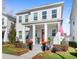 Charming two-story home featuring a well-manicured lawn and a welcoming front porch with a vibrant red door at 1073 Sadler Oaks Way, Winter Garden, FL 34787