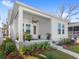 Charming front porch with lush landscaping and potted plants adding curb appeal at 1073 Sadler Oaks Way, Winter Garden, FL 34787