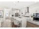 Modern kitchen with white cabinetry, a large island with seating, and stainless steel appliances at 1073 Sadler Oaks Way, Winter Garden, FL 34787