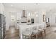 Bright kitchen with stainless steel appliances, a center island with seating, and white cabinets at 1073 Sadler Oaks Way, Winter Garden, FL 34787