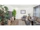 Cozy living room featuring soft seating, decorative rug, accent plants, and natural light at 1073 Sadler Oaks Way, Winter Garden, FL 34787