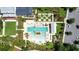 Aerial view of the community pool with lounge chairs and lush green landscaping around it at 1073 Sadler Oaks Way, Winter Garden, FL 34787