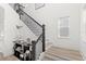 Bright staircase with wood treads, black railings and decorative console table at 1073 Sadler Oaks Way, Winter Garden, FL 34787