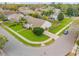 Aerial view of a single-Gathering home on a corner lot with a manicured lawn and mature landscaping at 1145 Lake Rogers Cir, Oviedo, FL 32765