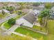 Aerial view of home and fenced backyard including mature trees and landscaping in a suburban neighborhood at 1145 Lake Rogers Cir, Oviedo, FL 32765