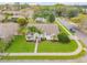 An aerial view of a home with lush landscaping on a corner lot in a quiet suburban neighborhood at 1145 Lake Rogers Cir, Oviedo, FL 32765