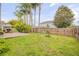 Wide shot of green backyard with a newly planted tree and a small patio at 1145 Lake Rogers Cir, Oviedo, FL 32765