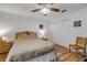 Bedroom with ceiling fan, wood floors, closet, and small nightstand at 1145 Lake Rogers Cir, Oviedo, FL 32765