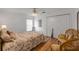 Charming bedroom featuring wood floors, a comfortable bed, and closet for storage at 1145 Lake Rogers Cir, Oviedo, FL 32765