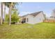 The home's exterior shows a patio with a grill and landscaped yard for outdoor enjoyment at 1145 Lake Rogers Cir, Oviedo, FL 32765